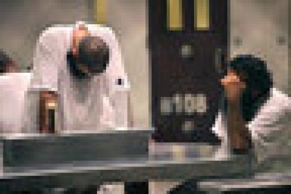 A group of detainees observe morning prayer before sunrise inside Camp Delta at Guantanamo Bay naval base in an October 28, 2009 file photo provided by the US Department of Defense. President Barack Obama urged lawmakers on Tuesday to give his plan to close the U.S. military prison at Guantanamo Bay, Cuba, a "fair hearing" and said he did not want to pass the issue to his successor when he leaves the White House next year